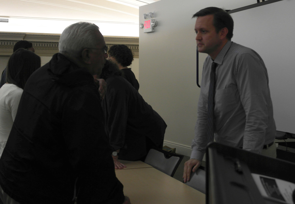 Dr. Brad Hare (right) talks with an audience member after the World AIDS Day Forum.