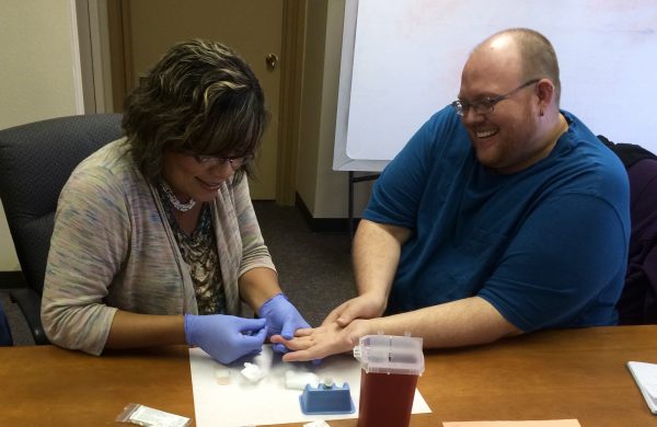 Staff in New Mexico practice rapid HIV testing during a CBA training.